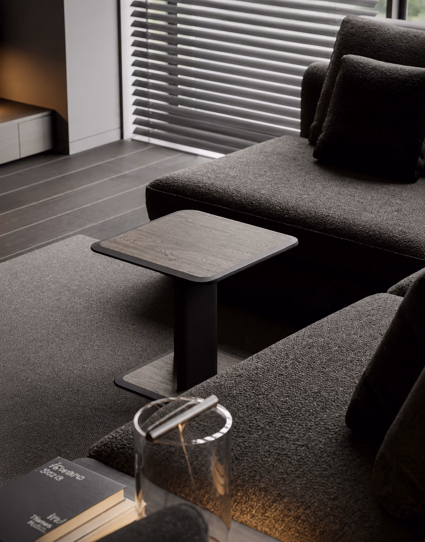 Dark sofa with a side table and a glass lamp